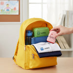 Mother placing Monster Nest name stamp into child's school bag