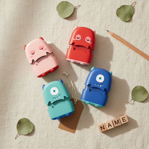 Four monster character personalised name stamps flat lay — Monster Nest by Parent Nest