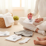 Mother labelling children's school clothes with Duo Nest double-sided name stamp