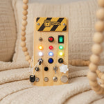 Large PowerBoard propped on sofa — wooden LED busy board lifestyle shot