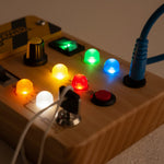 Extreme close-up of LED lights on PowerBoard — wooden STEM toy for kids