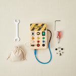 All PowerBoard components flat lay — wooden busy board with screws, wrench and screwdriver