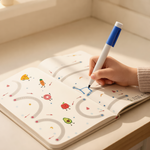 Extreme close-up of Little Nest wipe-clean tracing card being used by a child